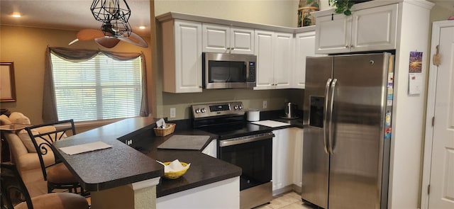 kitchen with white cabinetry, pendant lighting, a breakfast bar, and appliances with stainless steel finishes