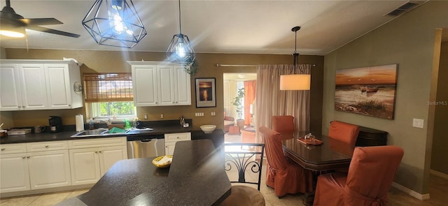 kitchen featuring white cabinetry, lofted ceiling, sink, dishwasher, and pendant lighting