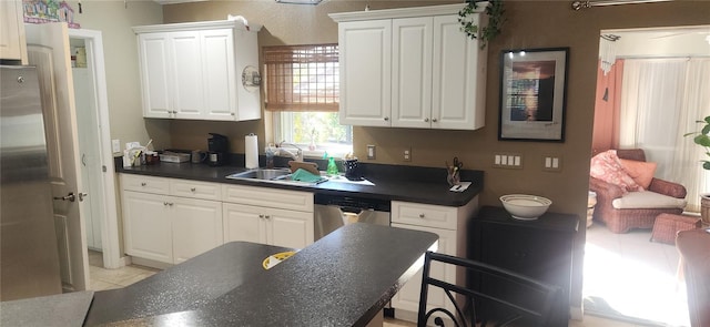 kitchen featuring sink, appliances with stainless steel finishes, and white cabinetry