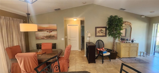 dining area featuring vaulted ceiling and light tile patterned floors