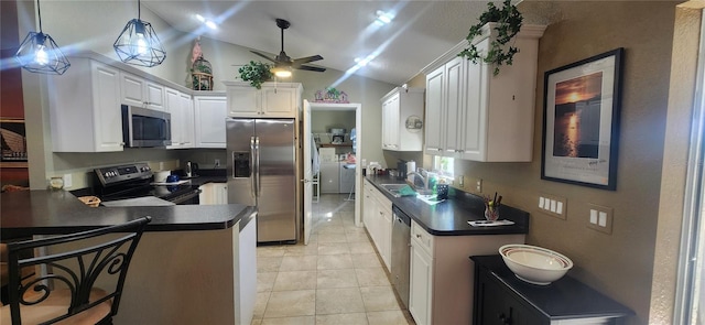 kitchen featuring sink, stainless steel appliances, kitchen peninsula, white cabinets, and hanging light fixtures