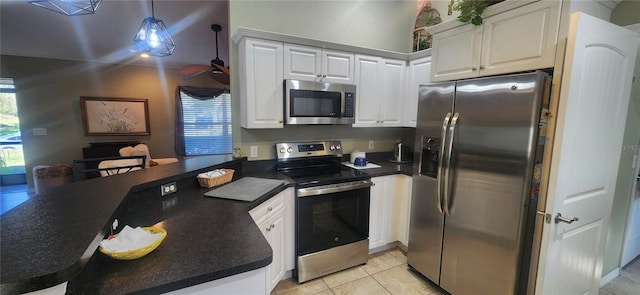 kitchen with white cabinets, appliances with stainless steel finishes, pendant lighting, and kitchen peninsula