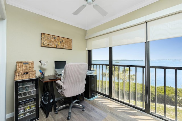 office area with ornamental molding, ceiling fan, and light wood-type flooring