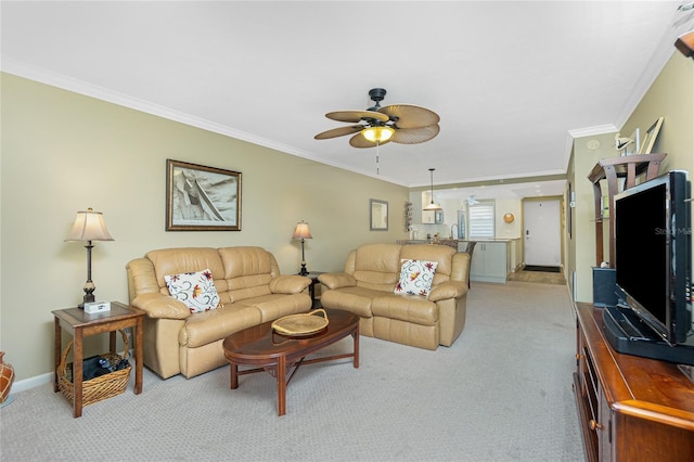 living room featuring crown molding, light colored carpet, and ceiling fan