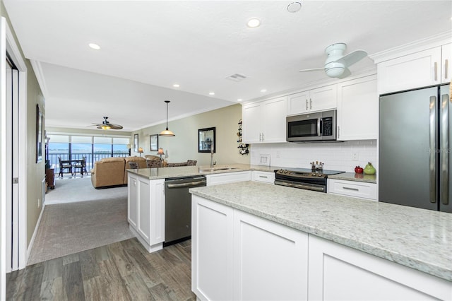 kitchen with ceiling fan, stainless steel appliances, kitchen peninsula, and white cabinets