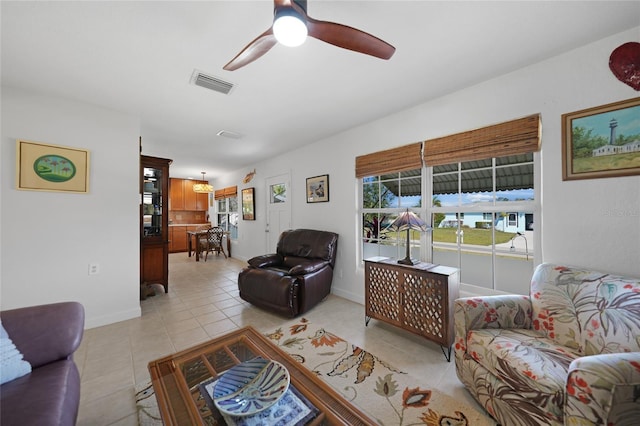 tiled living room featuring ceiling fan