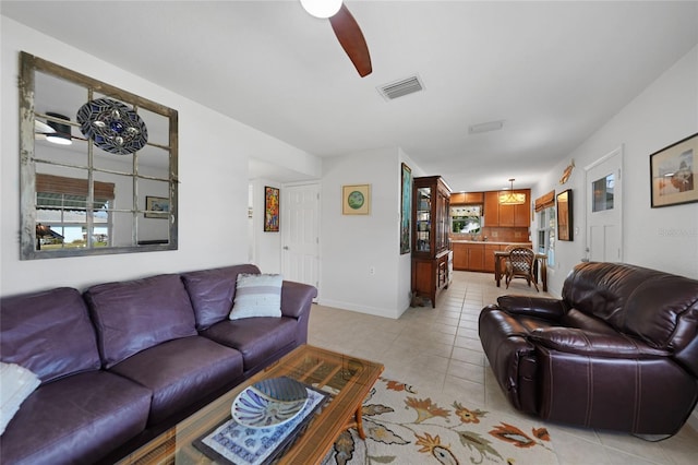 living room featuring light tile patterned flooring and ceiling fan