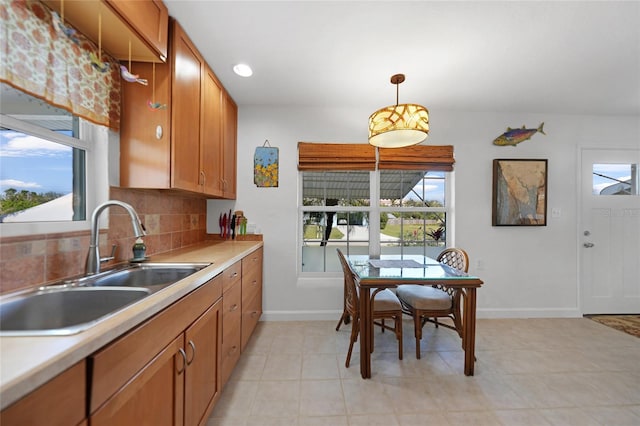 kitchen featuring sink, decorative light fixtures, and decorative backsplash