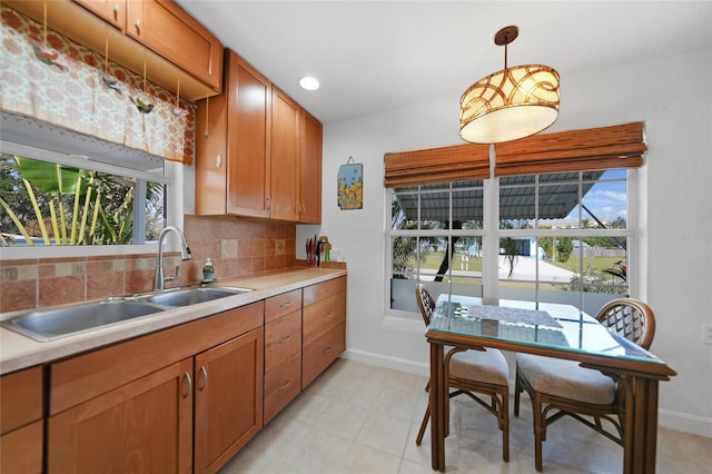 kitchen with pendant lighting, sink, and tasteful backsplash