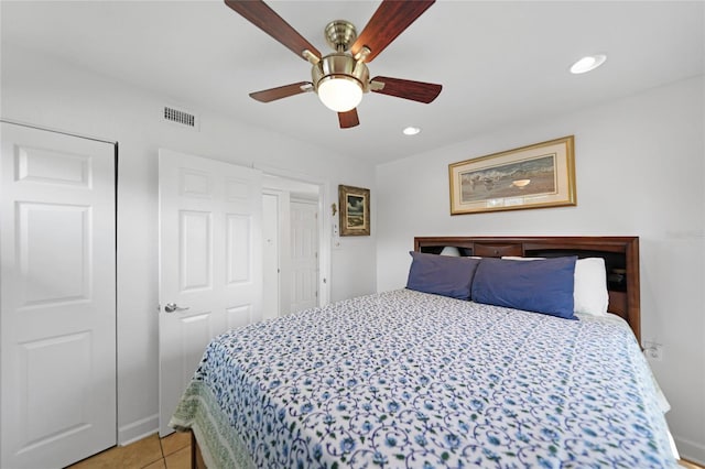 tiled bedroom featuring ceiling fan