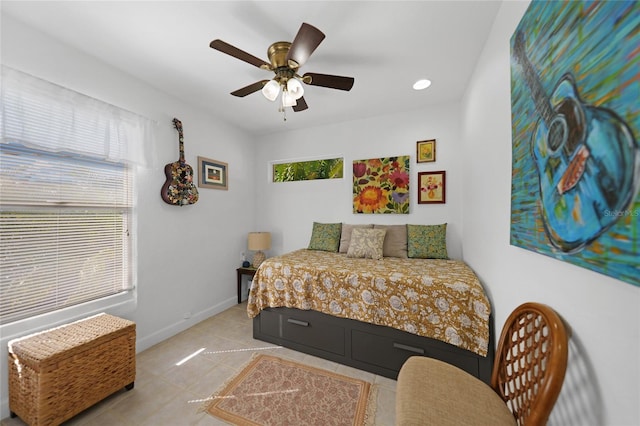 tiled bedroom featuring ceiling fan