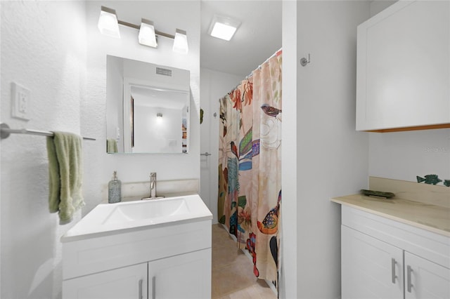 bathroom featuring tile patterned flooring, vanity, and a shower with curtain