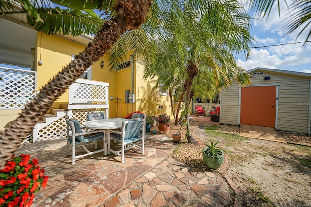 view of patio featuring a storage unit