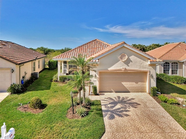 mediterranean / spanish-style home featuring a garage, a front yard, and cooling unit