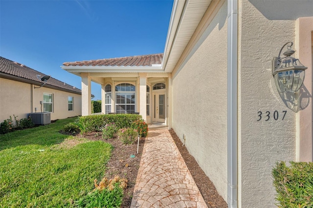 exterior space featuring a yard and central AC unit