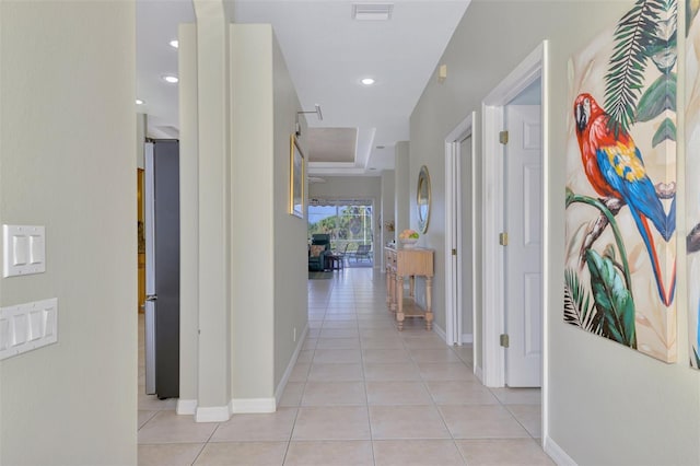 hall with light tile patterned floors