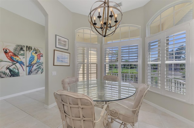 tiled dining room with an inviting chandelier and a healthy amount of sunlight