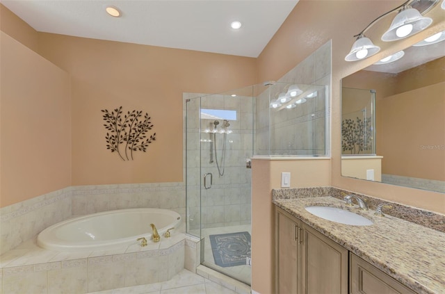 bathroom with vanity and separate shower and tub