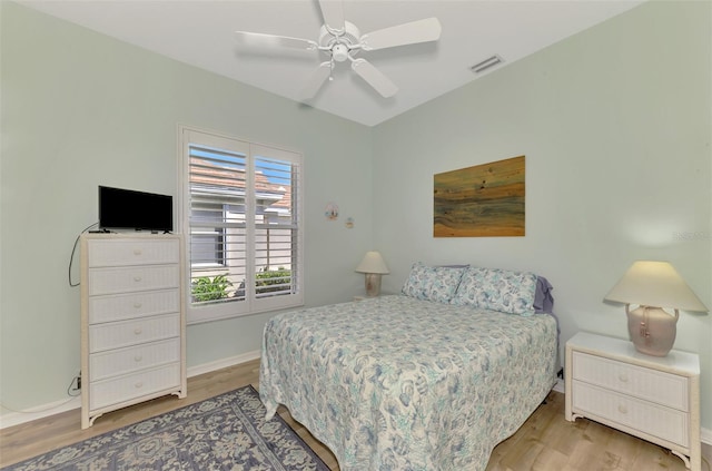 bedroom with ceiling fan and light hardwood / wood-style flooring