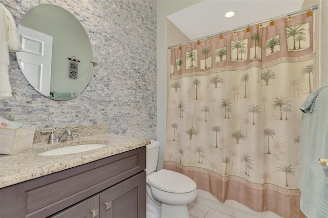 bathroom with vanity, tile patterned flooring, and toilet