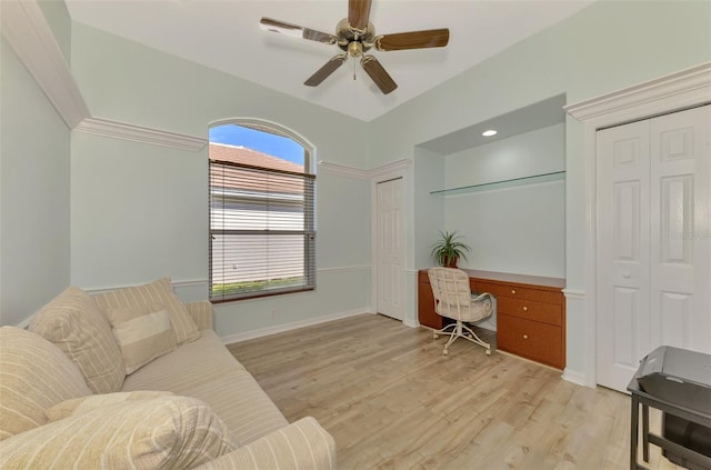 office area with ceiling fan, built in desk, and light hardwood / wood-style floors