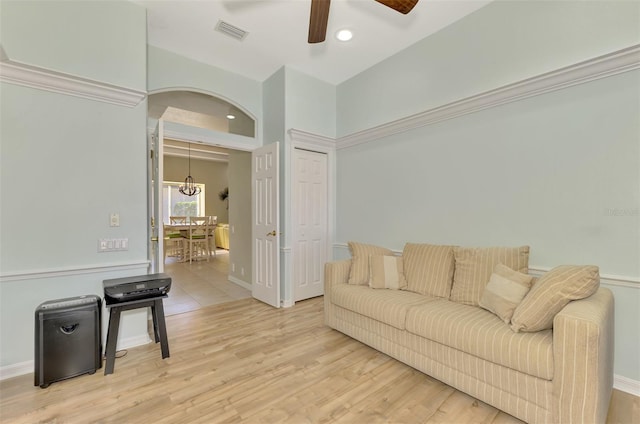 living room featuring wood-type flooring and ceiling fan