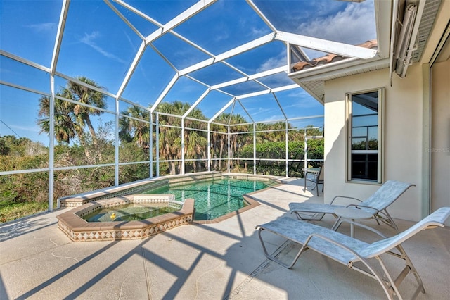 view of swimming pool with a patio, glass enclosure, and an in ground hot tub