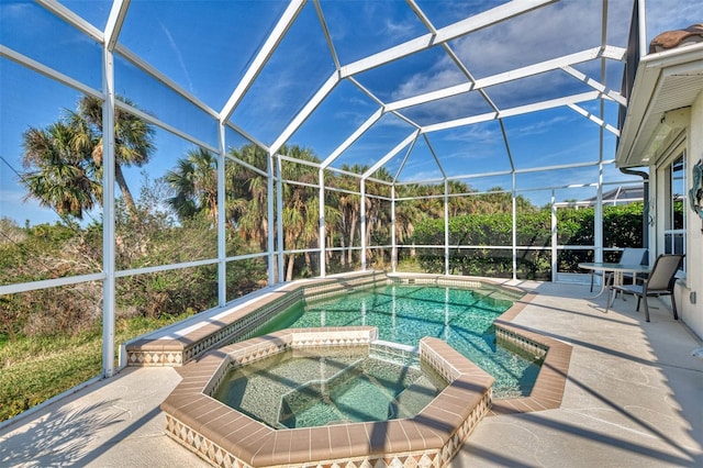 view of swimming pool featuring an in ground hot tub, glass enclosure, and a patio