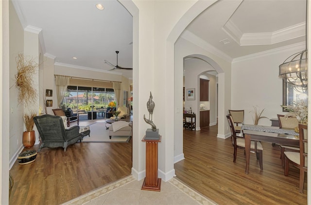 entrance foyer with crown molding and light hardwood / wood-style flooring