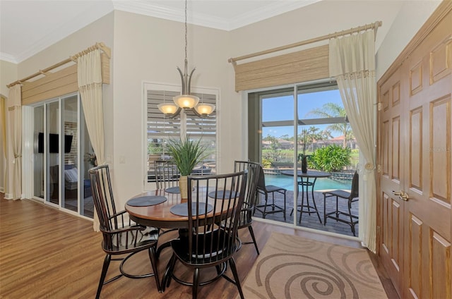 dining room featuring hardwood / wood-style flooring and crown molding