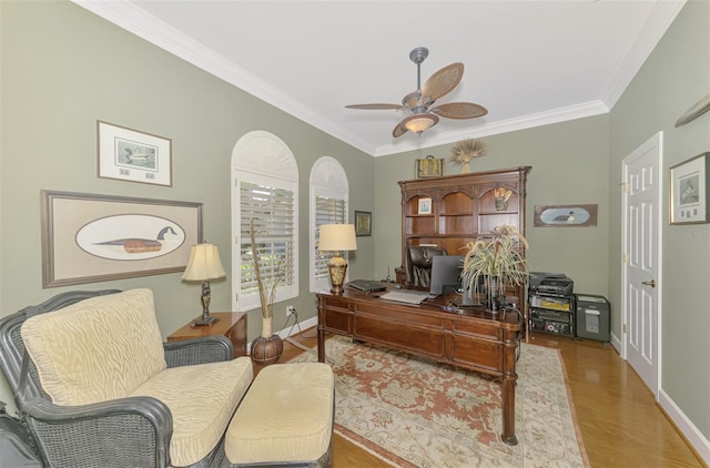 home office with ornamental molding, ceiling fan, and light hardwood / wood-style floors