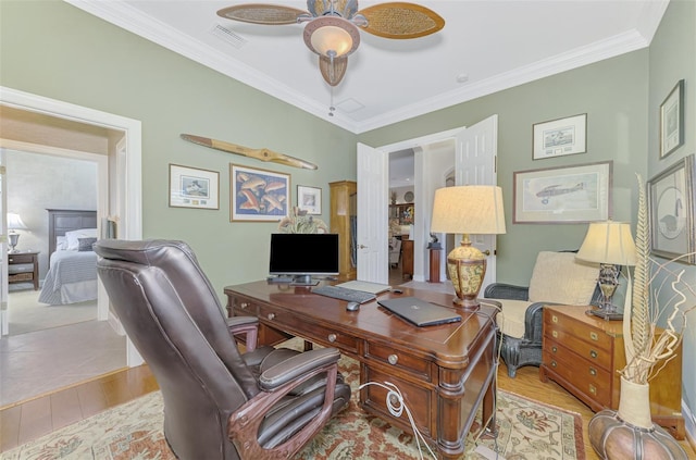 office space with ceiling fan, ornamental molding, and light hardwood / wood-style floors