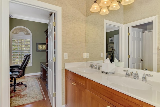 bathroom with vanity, hardwood / wood-style floors, and crown molding