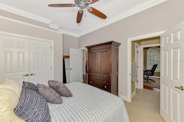 carpeted bedroom featuring crown molding, a closet, and ceiling fan