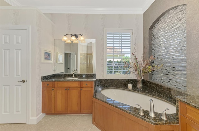 bathroom featuring a washtub, vanity, crown molding, and tile patterned floors