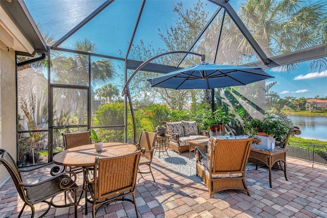 view of patio featuring a water view, an outdoor hangout area, and glass enclosure