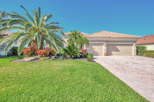 view of front of home with a garage and a front lawn