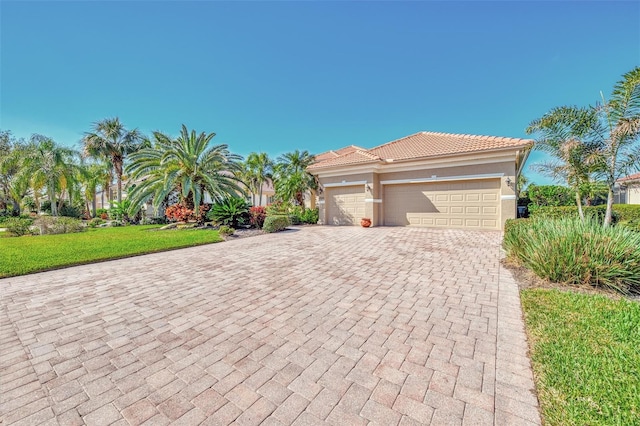 view of front of property with a garage and a front lawn