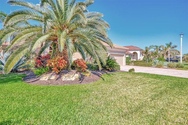 view of front of home featuring a garage and a front lawn