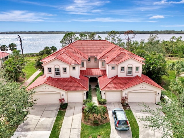 view of front facade featuring a garage and a water view