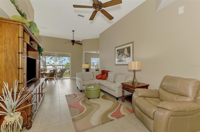 tiled living room with a towering ceiling and ceiling fan