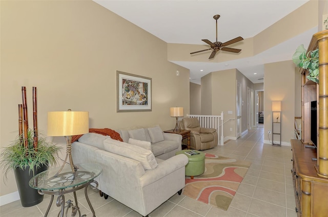 living room with light tile patterned floors, a towering ceiling, and ceiling fan