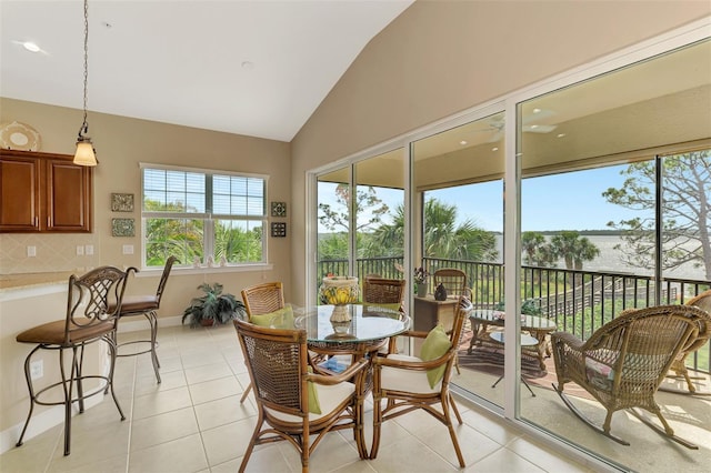 sunroom featuring vaulted ceiling