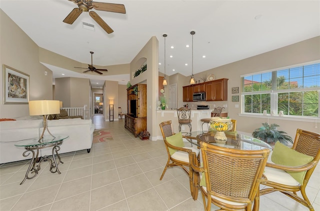 dining space featuring ceiling fan and light tile patterned flooring