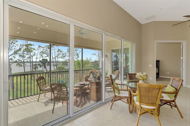 sunroom / solarium with a water view and ceiling fan