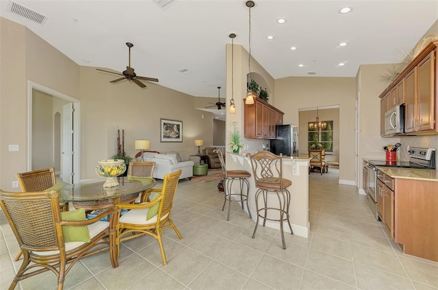 kitchen featuring light tile patterned floors, appliances with stainless steel finishes, backsplash, decorative light fixtures, and kitchen peninsula