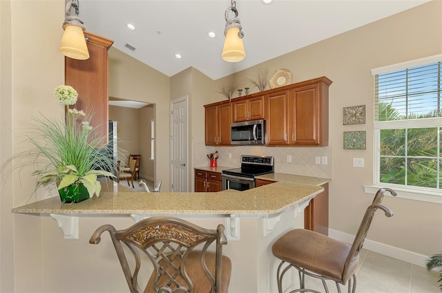 kitchen with pendant lighting, kitchen peninsula, and appliances with stainless steel finishes