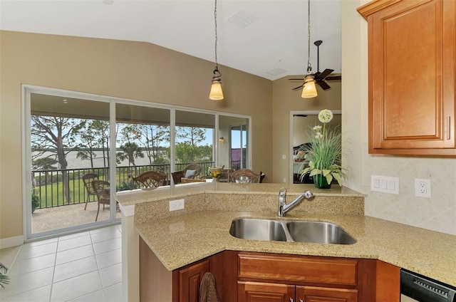 kitchen featuring dishwasher, sink, a healthy amount of sunlight, and kitchen peninsula