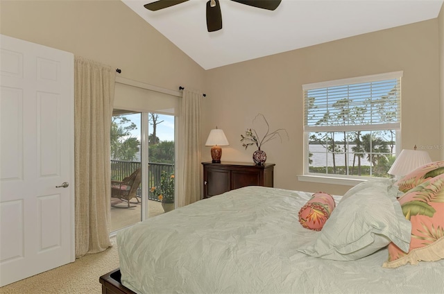 carpeted bedroom featuring ceiling fan, access to exterior, vaulted ceiling, and multiple windows