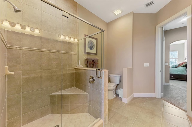 bathroom with walk in shower, tile patterned floors, and toilet